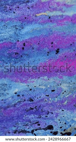 Shimmering liquid background. Sparkling fluid. Acrylic paint motion. Blue purple blend stream of wet pigment with black blots in trendy vibrant abstract art.