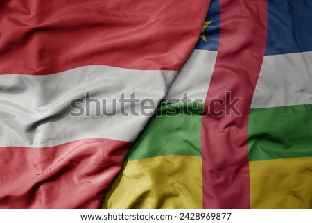 big waving national colorful flag of central african republic and national flag of austria . macro