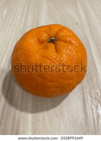 A orange close up with textured on the table