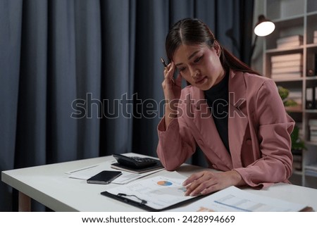 Tired, sleepy, bored Asian businesswoman from sitting at a desk for a long time Work in financial documents, accounting, statistics and have office syndrome.