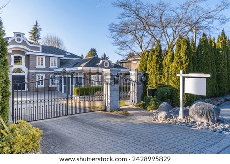 House for sale in Vancouver, Canada. Real estate sign in front of a house