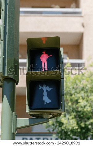 red traffic signal with a human figure during April Fair in Seville, Spain Andalusia