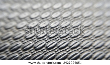 a silver snake skin as a background. Macro.