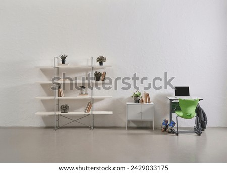 Grey stone wall background, school desk, opening of schools and starting school concept.