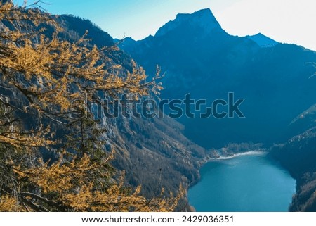 Panoramic aerial view of alpine lake Leopoldsteinersee in Eisenerz, Styria, Austria. Looking at majestic mountain peaks of Eisenerzer massif. Wanderlust in remote Austrian Alps. Idyllic hiking trail