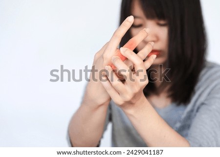Woman has pain in her knuckles or hand from heavy use on white background. Royalty-Free Stock Photo #2429041187