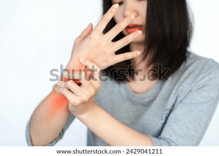 Woman has wrist pain or arm pain from heavy use on white background. Royalty-Free Stock Photo #2429041211