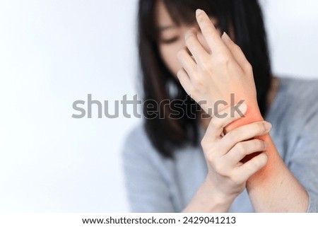 Woman has wrist pain or arm pain from heavy use on white background. Royalty-Free Stock Photo #2429041213