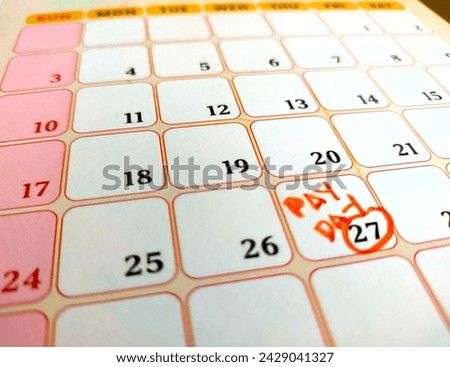 payday concept calendar with marker and circled day of salary.
