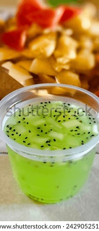 Fresh drink originally from Indonesia is named Es Kuwut. it contains of   ice, basil, melon or cucumbar, and syrup pandan. 
