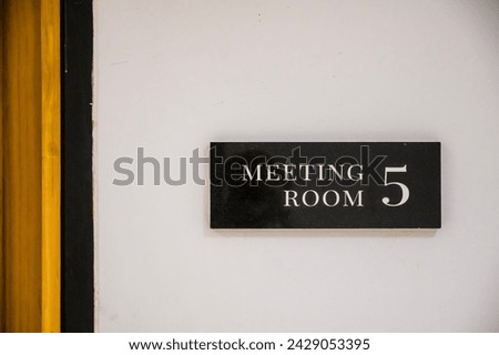 The sign says meeting room.Sign in front of the room