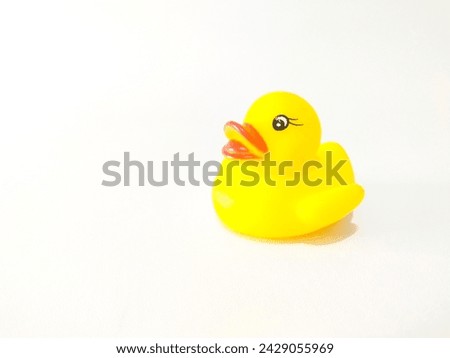 Cute yellow rubber duck isolated over white background.