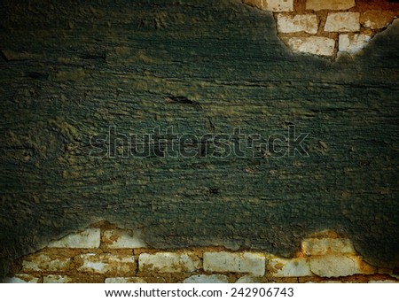 Brick wall painted with a wooden board