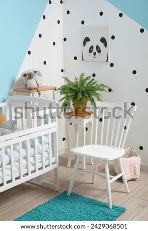 Interior of stylish children's bedroom with crib and picture