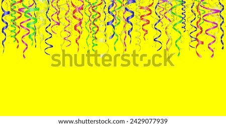 Falling confetti and curly colorful shiny streamer on yellow background. Empty space for text.
