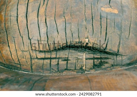 Abstract photo of heavily cracked processed wood. Cracks on the surface of the wooden decoration. Smooth wood surface with significant cracks. Wood texture, wooden, texture.