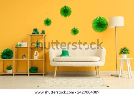 Interior of festive living room with white sofa and decorations for St. Patrick's Day celebration