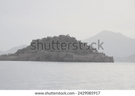 The Unesco World Heritage site of Spinalonga, an abandoned historic Bastion Fortress and former Leper Colony on the rocky, arid Islet of Kalydon near Elounda in the waters of Mirabello Bay, Crete.  Royalty-Free Stock Photo #2429085917