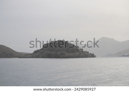 The Unesco World Heritage site of Spinalonga, an abandoned historic Bastion Fortress and former Leper Colony on the rocky, arid Islet of Kalydon near Elounda in the waters of Mirabello Bay, Crete.  Royalty-Free Stock Photo #2429085927