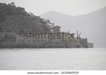 The Unesco World Heritage site of Spinalonga, an abandoned historic Bastion Fortress and former Leper Colony on the rocky, arid Islet of Kalydon near Elounda in the waters of Mirabello Bay, Crete.  Royalty-Free Stock Photo #2429085929