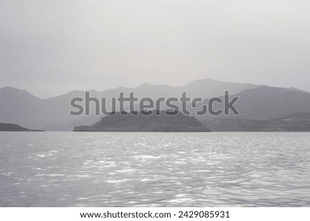 The Unesco World Heritage site of Spinalonga, an abandoned historic Bastion Fortress and former Leper Colony on the rocky, arid Islet of Kalydon near Elounda in the waters of Mirabello Bay, Crete.  Royalty-Free Stock Photo #2429085931