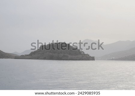 The Unesco World Heritage site of Spinalonga, an abandoned historic Bastion Fortress and former Leper Colony on the rocky, arid Islet of Kalydon near Elounda in the waters of Mirabello Bay, Crete.  Royalty-Free Stock Photo #2429085935