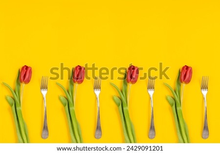 Holiday card. Food delivery. Dinner time. Red tulips with fork on yellow background. Invitation on woman day March 8th. Banner copy space. Cleaning service certificate. Clean kitchen. Testy desert.