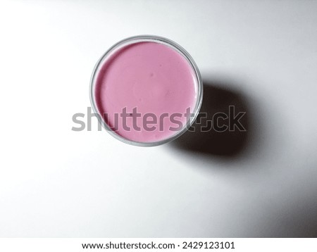  close-up Grape-flavored yogurt in a transparent glass isolated on a white background.