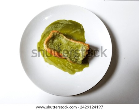close-up of cheese bread with matcha lava on a white plate isolated on a white background