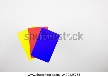 Three cards for football referee on a white table. Blue, red, yellow cards in football after changing the rules Royalty-Free Stock Photo #2429125755