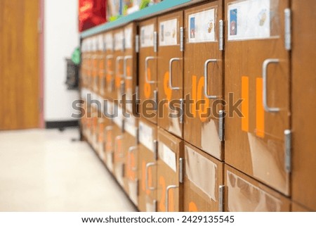 Classroom corner with row of cabinet number and picture name tag at pre kindergarten school, Dallas, Texas, two tier lockers handle easy to open, roomy cubbies organizing, sorting projects, toys. USA
