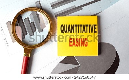 Quantitative easing text on sticky on chart Royalty-Free Stock Photo #2429160547