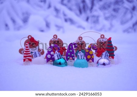 Toy gingerbread men on a background of snow.