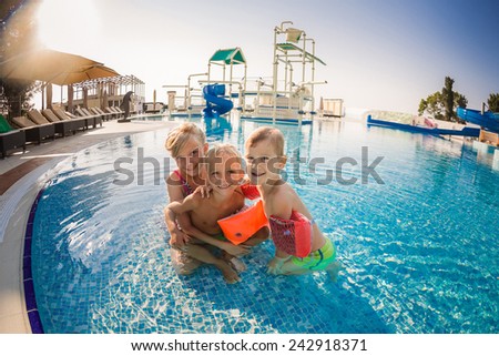 Three children having fun at the swimming pool