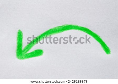 Arrow sign drawn on white paper with green crayons