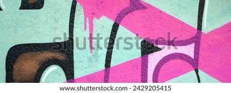 Colorful background of graffiti painting artwork with bright aerosol outlines on wall. Old school street art piece made with aerosol spray paint cans. Contemporary youth culture backdrop Royalty-Free Stock Photo #2429205415
