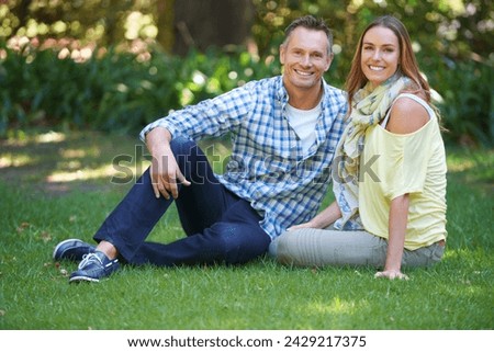 Portrait, relax and couple with smile on grass for summer romance, trees and fun outdoor date. Love, mature man and happy woman in garden with morning sunshine, park and marriage bonding in nature.