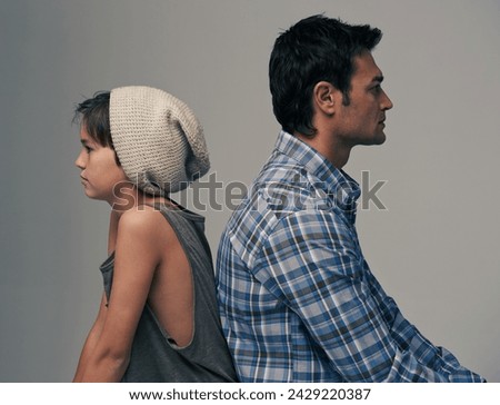 Father, son and back in disagreement, argument or ignore with fashion on a gray studio background. Profile of dad, kid or young child in casual clothing, conflict or fight for parenthood or childhood Royalty-Free Stock Photo #2429220387