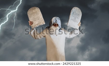 prophet Moses holds the tablets with the ten commandments (The tablets contain a quote from the Bible, in Hebrew, translates as Do not take a life , Follow God's path) Royalty-Free Stock Photo #2429221325