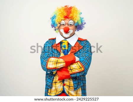 Mr Clown. Portrait of Funny comedian face Clown man in colorful uniform wearing wig standing arms crossed smiling to camera. Happy expression male bozo in various pose on isolated background.