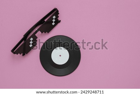 Stereo headphones with vinyl record on pink background. Music concept