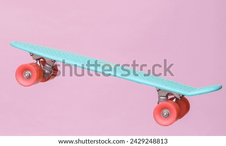 Youth plastic penny board isolated on pink background