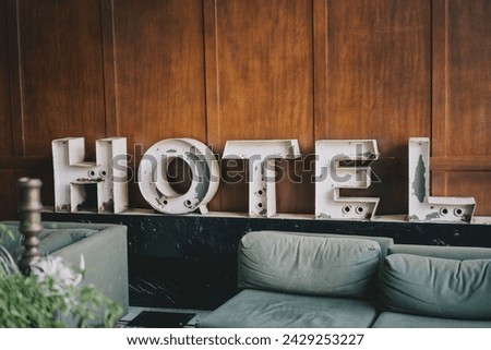 Hotel sign on the wooden wall, vintage filter, vintage tone