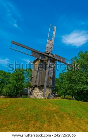 Wooden windmill at Mihkli farmstead museum in Estonia. Royalty-Free Stock Photo #2429261065