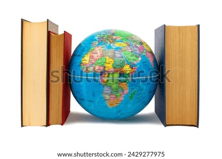 Globe escorted by books where you can see Africa and Europe: protection and defense concept. Books, a source of knowledge, flank the Earth as defense, protection and care.