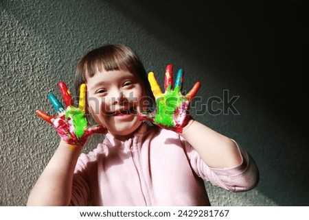 Cute little girl with painted hands Royalty-Free Stock Photo #2429281767