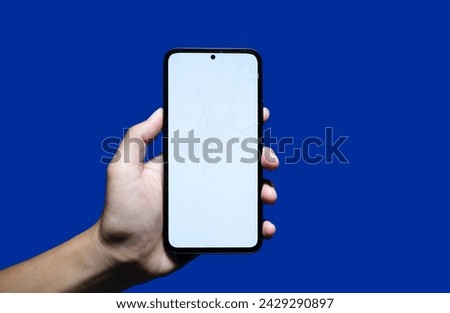 Hand holding a Broken screen black smartphone with a white screen. with copy space. Designing a frameless smartphone application