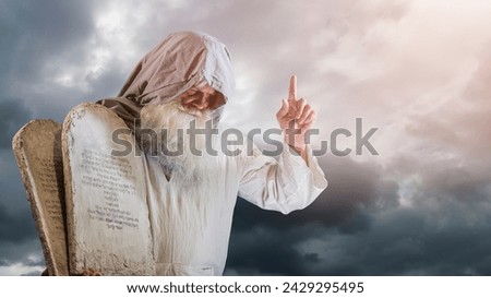prophet Moses holds the tablets with the ten commandments (The tablets contain a quote from the Bible, in Hebrew, translates as Do not take a life , Follow God's path) Royalty-Free Stock Photo #2429295495