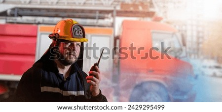 Portrait of a male firefighter holding a walkie-talkie