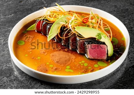 tuna tataki with vegetables and sauce on white plate Royalty-Free Stock Photo #2429298955